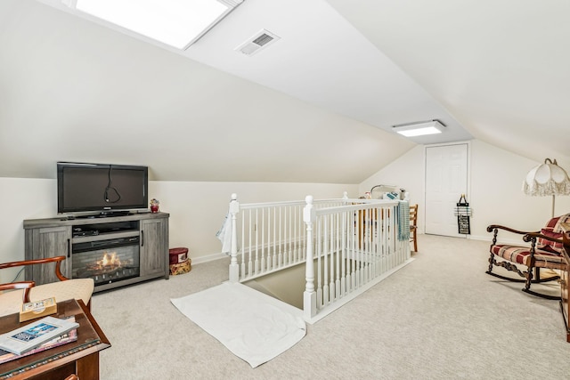 additional living space with vaulted ceiling, baseboards, visible vents, and light colored carpet