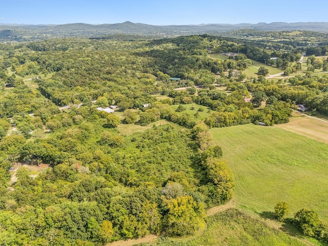 aerial view with a wooded view and a mountain view