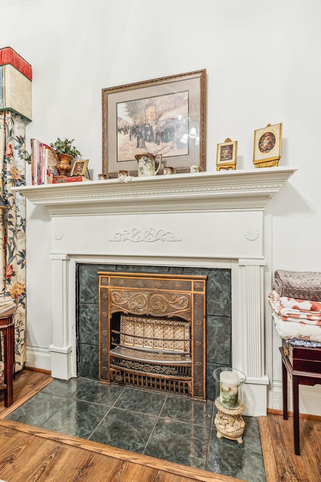 interior details featuring wood finished floors and a fireplace with flush hearth