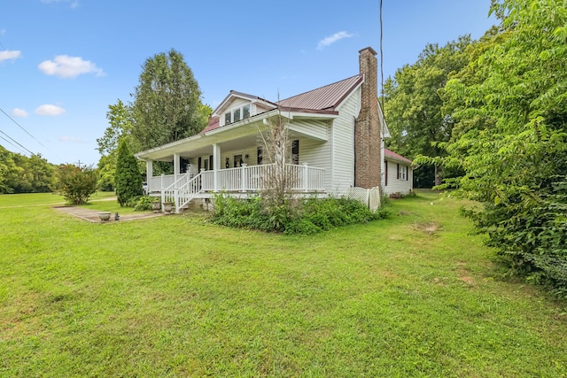 view of property exterior featuring a lawn and covered porch