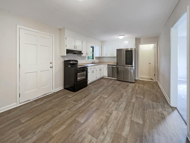 kitchen with baseboards, appliances with stainless steel finishes, dark wood-style flooring, under cabinet range hood, and white cabinetry