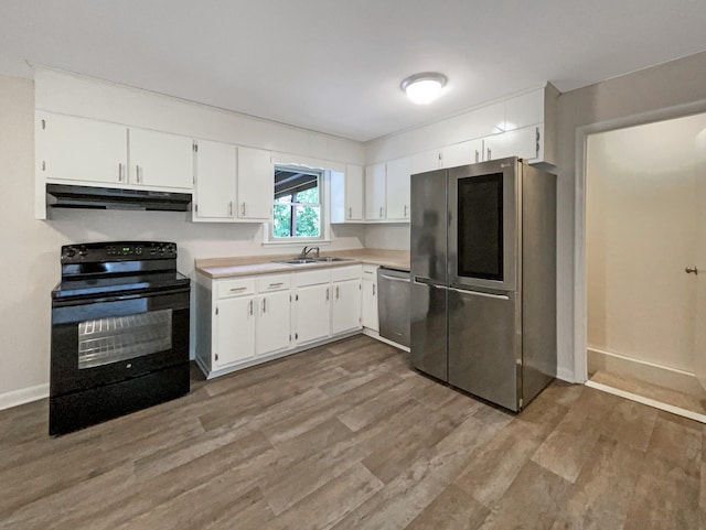 kitchen featuring stainless steel appliances, light countertops, under cabinet range hood, white cabinetry, and a sink