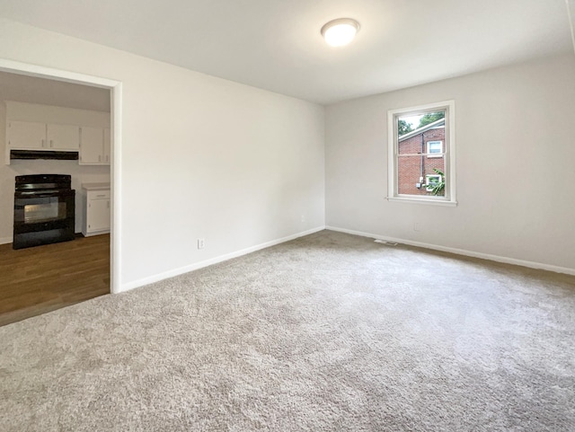 carpeted spare room with baseboards