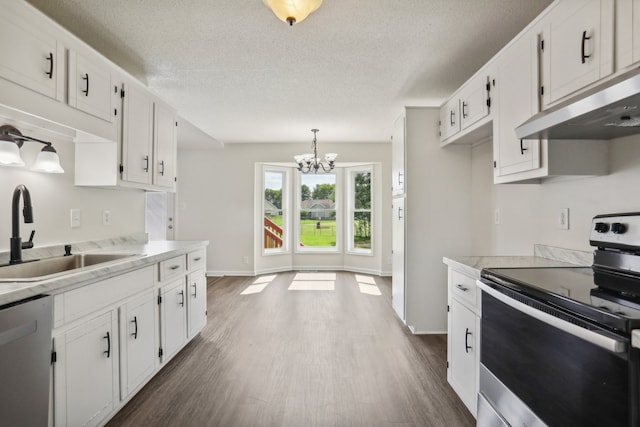 kitchen with appliances with stainless steel finishes, dark wood-type flooring, white cabinetry, and sink