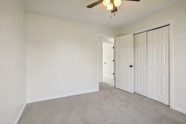 unfurnished bedroom featuring a closet, ceiling fan, and light carpet