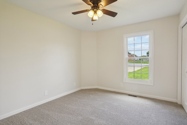 spare room with ceiling fan and carpet floors