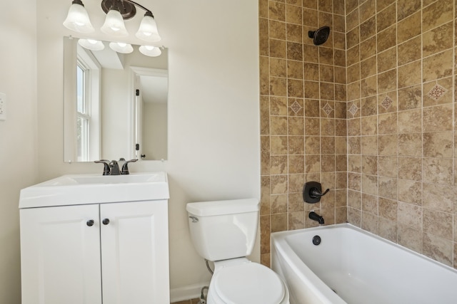 full bathroom with tiled shower / bath, toilet, and vanity