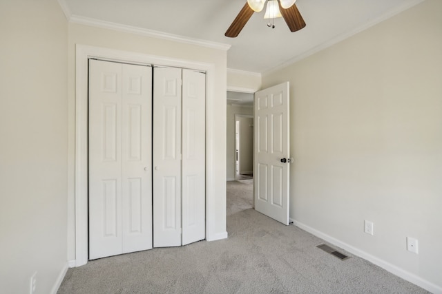 unfurnished bedroom featuring a closet, ceiling fan, and light carpet