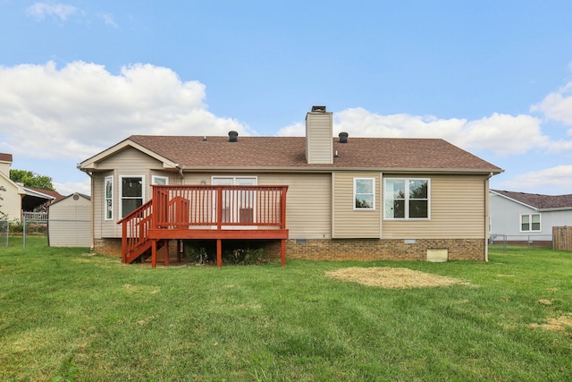 rear view of house featuring a wooden deck and a lawn