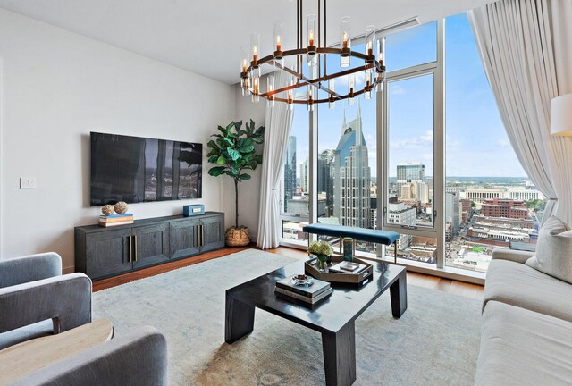 living room featuring an inviting chandelier and wood-type flooring