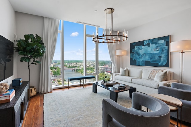 living room with floor to ceiling windows, an inviting chandelier, and hardwood / wood-style flooring