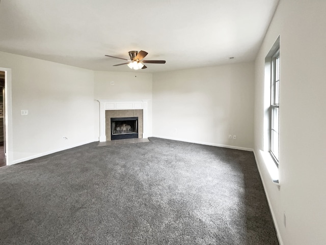 unfurnished living room featuring a fireplace, plenty of natural light, and ceiling fan