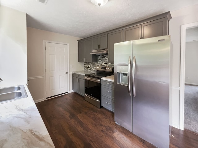 kitchen featuring dark colored carpet, gray cabinets, tasteful backsplash, appliances with stainless steel finishes, and sink