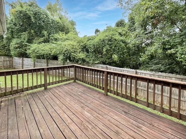 wooden terrace featuring a yard