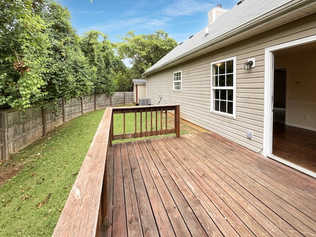 wooden terrace featuring a lawn