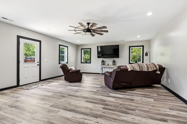 living room featuring ceiling fan and wood-type flooring