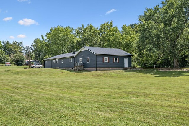 rear view of property with a lawn