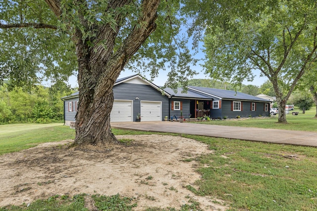 single story home with a garage and a front yard