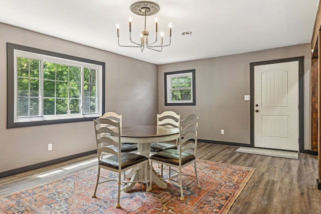 dining room with an inviting chandelier and hardwood / wood-style floors