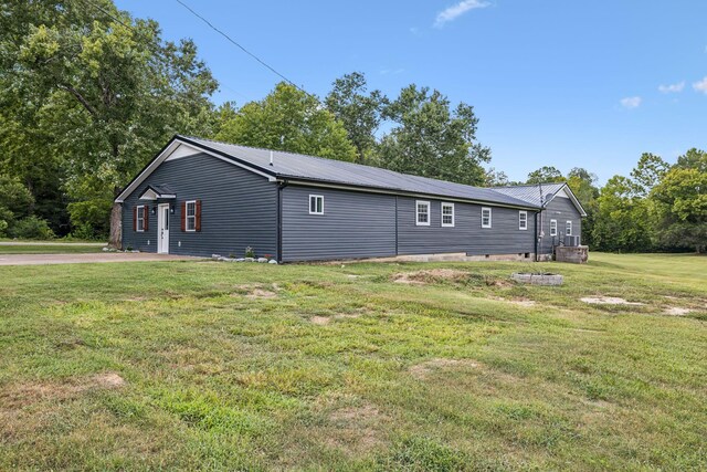 view of side of home featuring a lawn