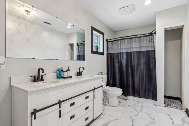 bathroom with toilet, double vanity, and tile patterned flooring