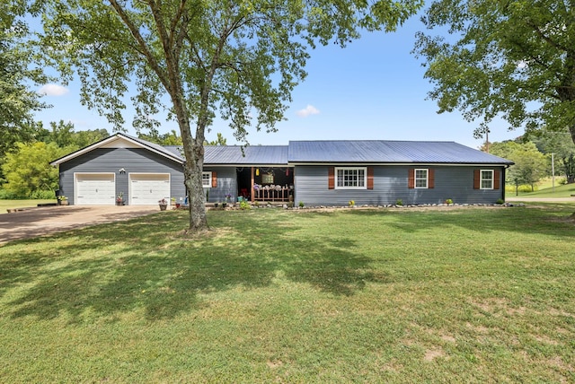 ranch-style house with metal roof, concrete driveway, a front lawn, and an attached garage