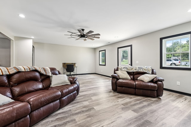 living room featuring ceiling fan and light hardwood / wood-style flooring