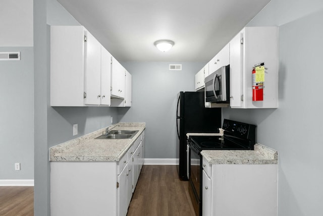 kitchen featuring white cabinetry, sink, wood-type flooring, and black electric range