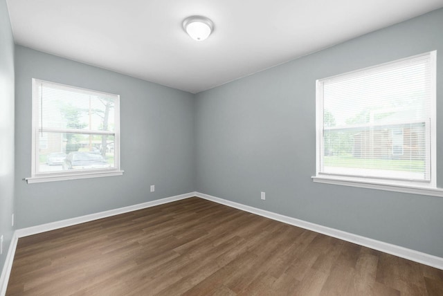 spare room with hardwood / wood-style flooring and a healthy amount of sunlight