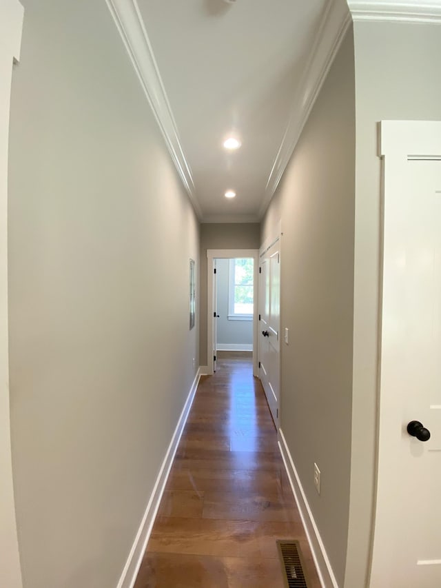 hall featuring baseboards, visible vents, dark wood-style floors, ornamental molding, and recessed lighting