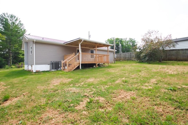 rear view of house featuring cooling unit, a fenced backyard, a yard, stairway, and a wooden deck