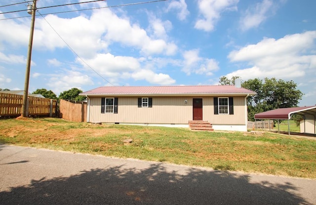 view of front of house featuring crawl space, metal roof, a front lawn, and fence