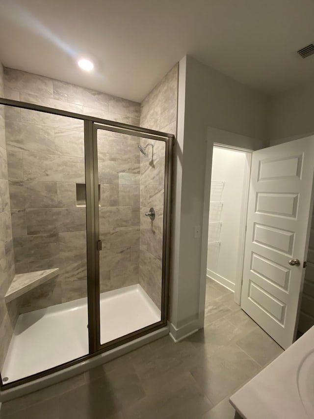 bathroom with a shower with door