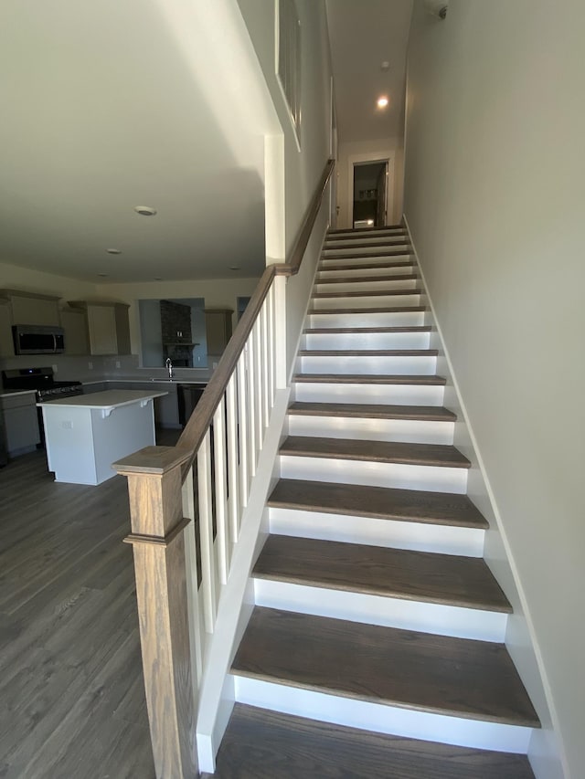 staircase featuring hardwood / wood-style flooring