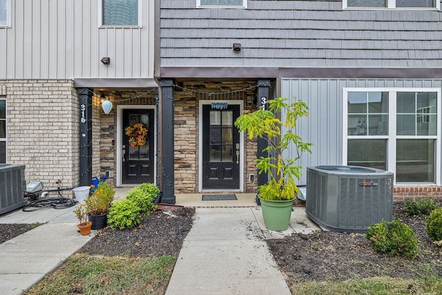 doorway to property featuring central AC