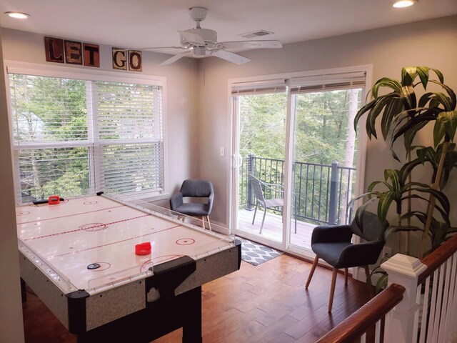 game room with hardwood / wood-style floors and ceiling fan