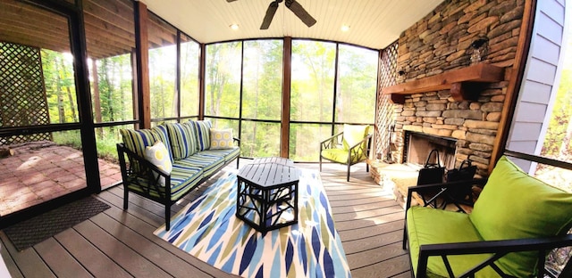 sunroom / solarium with a fireplace, lofted ceiling, wooden ceiling, and plenty of natural light