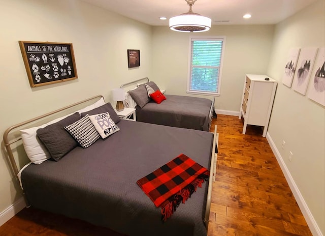 bedroom with dark hardwood / wood-style floors