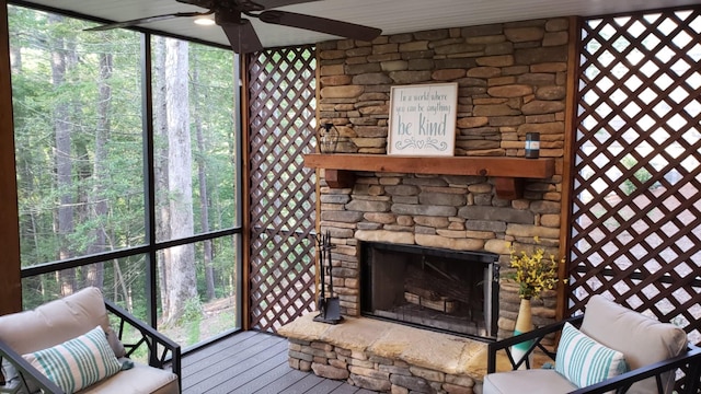 interior space featuring a fireplace, plenty of natural light, and ceiling fan