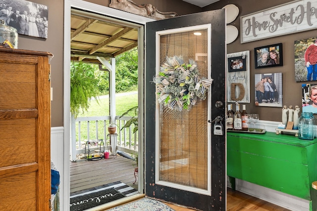 doorway to outside featuring indoor bar and hardwood / wood-style flooring