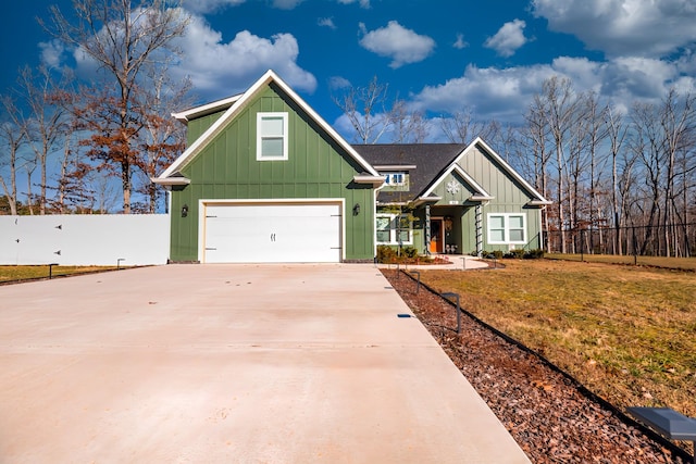 view of front facade with driveway, board and batten siding, and a front yard