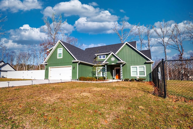 view of front of home with driveway, a garage, fence, and a front lawn