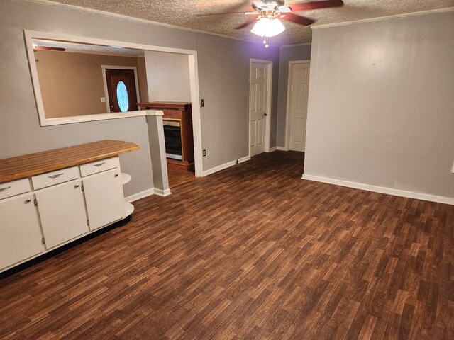 interior space featuring ceiling fan, a textured ceiling, and hardwood / wood-style floors