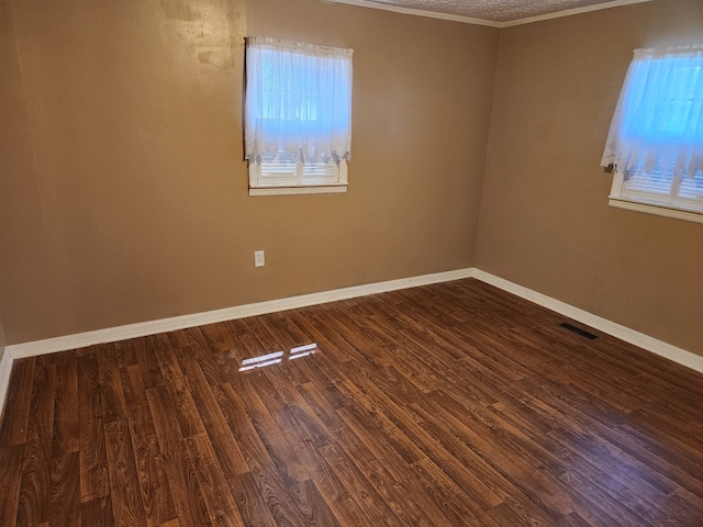 empty room with wood-type flooring and ornamental molding