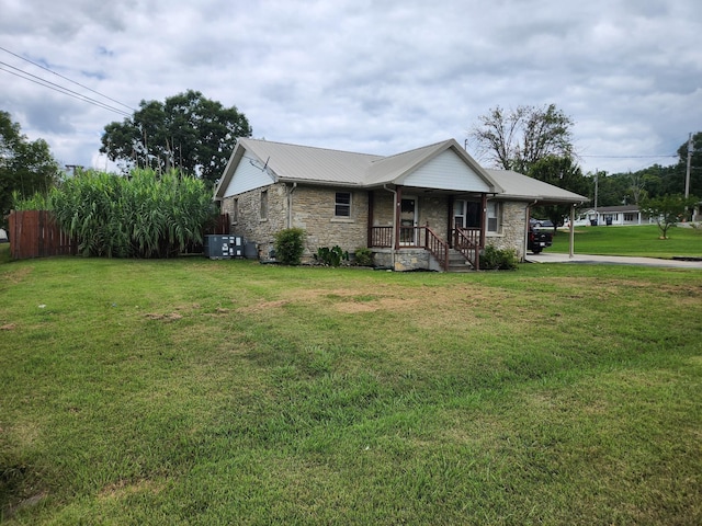 view of front facade with a front yard and a carport