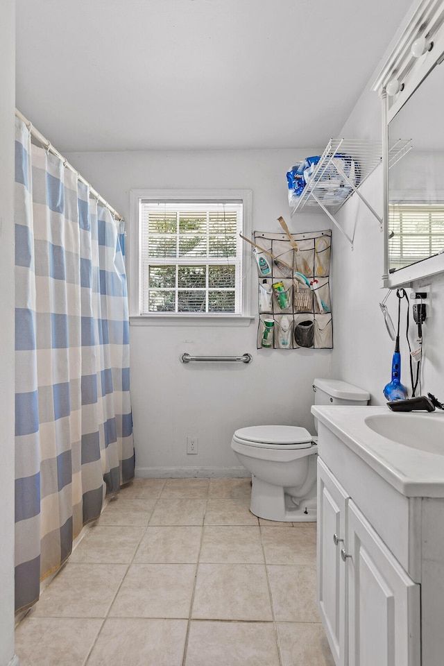 bathroom with tile patterned flooring, toilet, and vanity