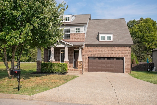 craftsman house featuring a garage and a front lawn