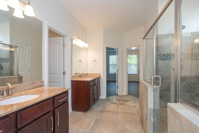 bathroom with walk in shower and vanity