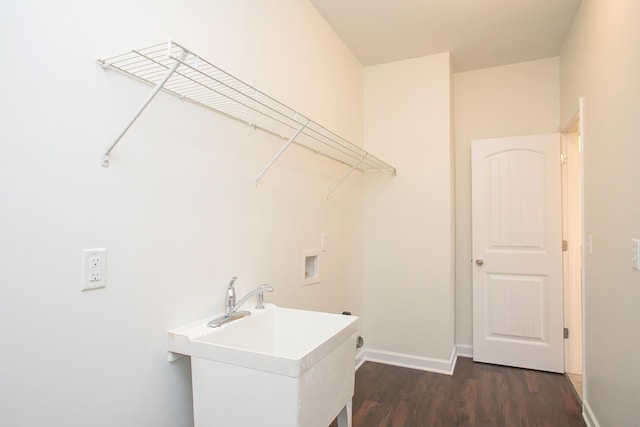 washroom with hookup for a washing machine, dark wood-type flooring, and sink