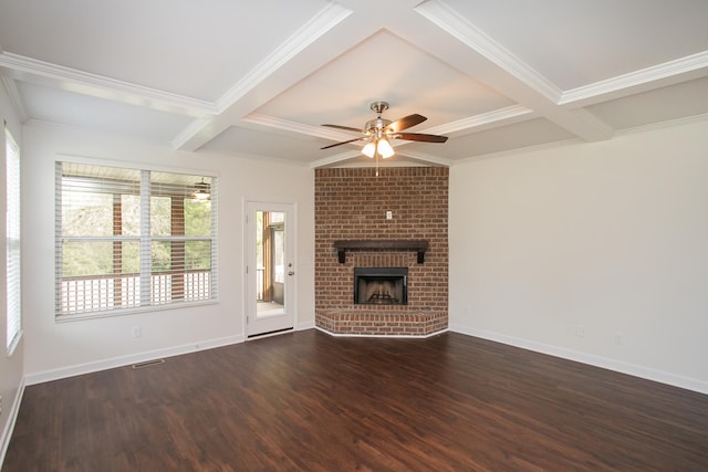 unfurnished living room with a brick fireplace, dark hardwood / wood-style floors, and beam ceiling